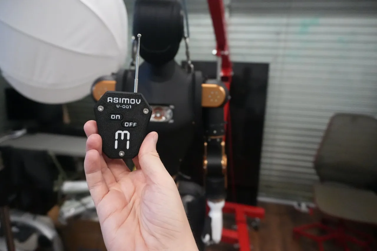 Wireless e-stop remote held in front of Asimov 1