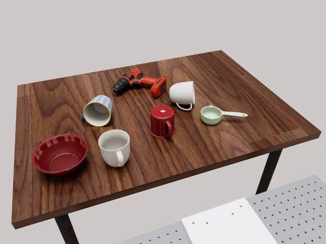 RoboLab scene: mugs, a measuring cup and a bowl for reorientation tasks.