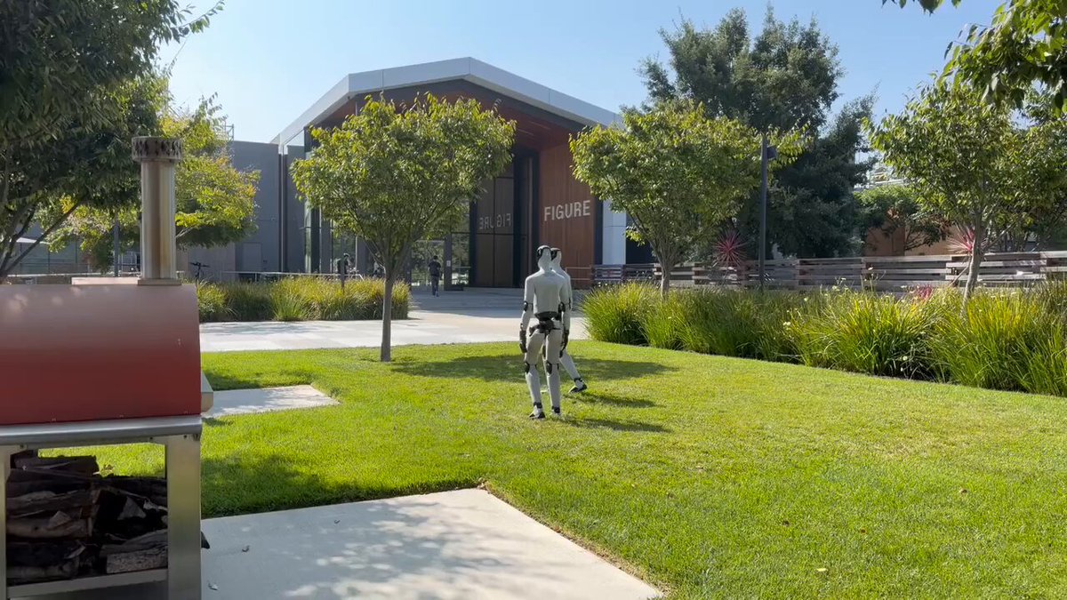 Figure humanoids walk around the company HQ