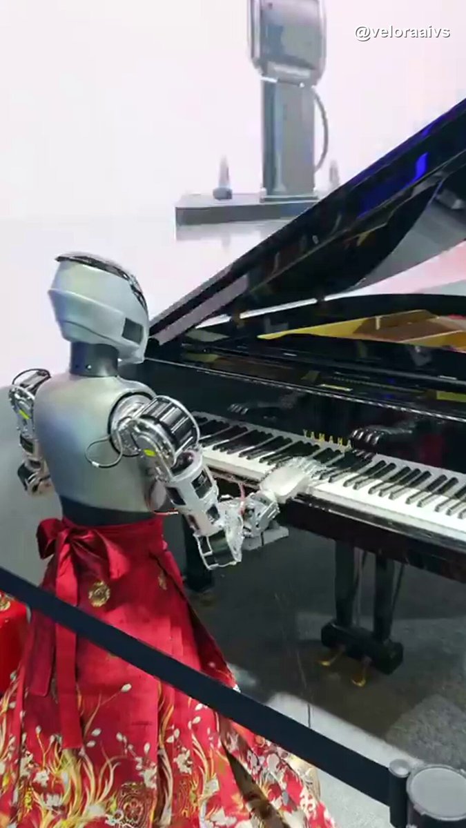 Robot pianist plays a grand piano with metal fingers